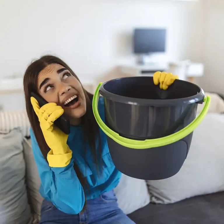 Woman Holding a bucket under leak
